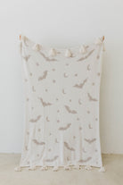 one side of bat tassel blanket - white with grey bats, moons, and stars
