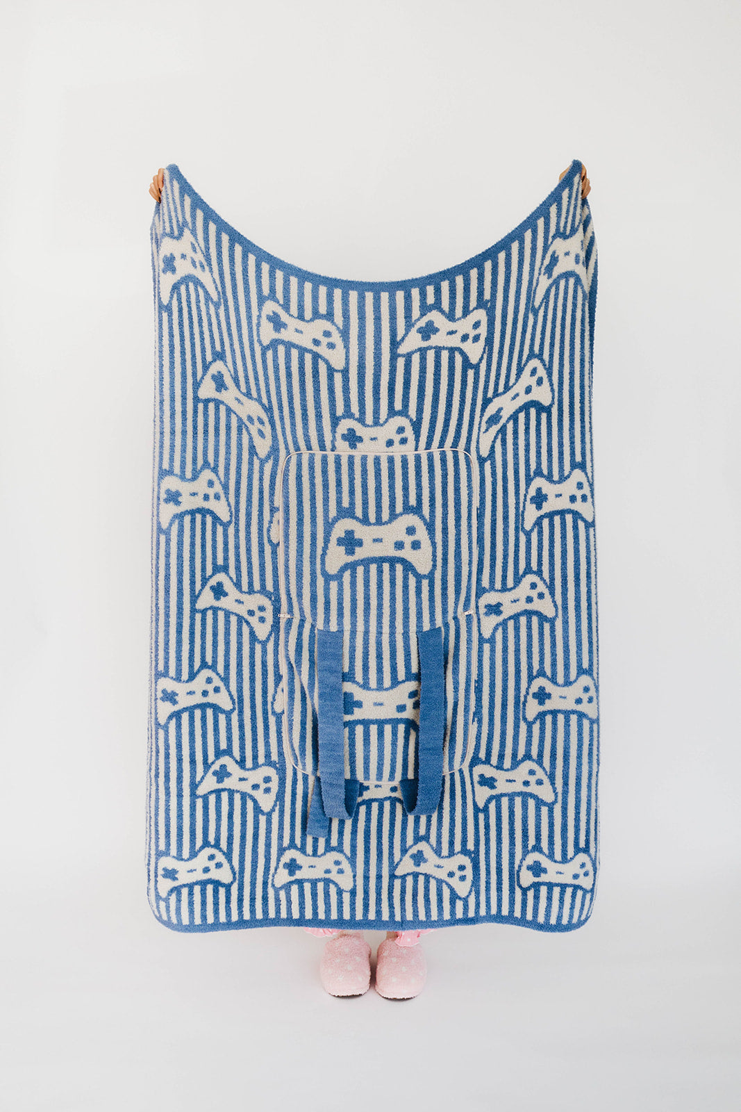 Blue and white patterned blanket with game controller design on a white background