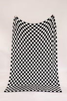 Black and white checkered blanket on a white background
