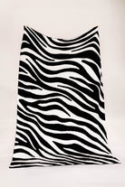 Black and white zebra-striped fabric on a white background