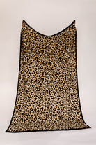 Leopard print blanket on a white background