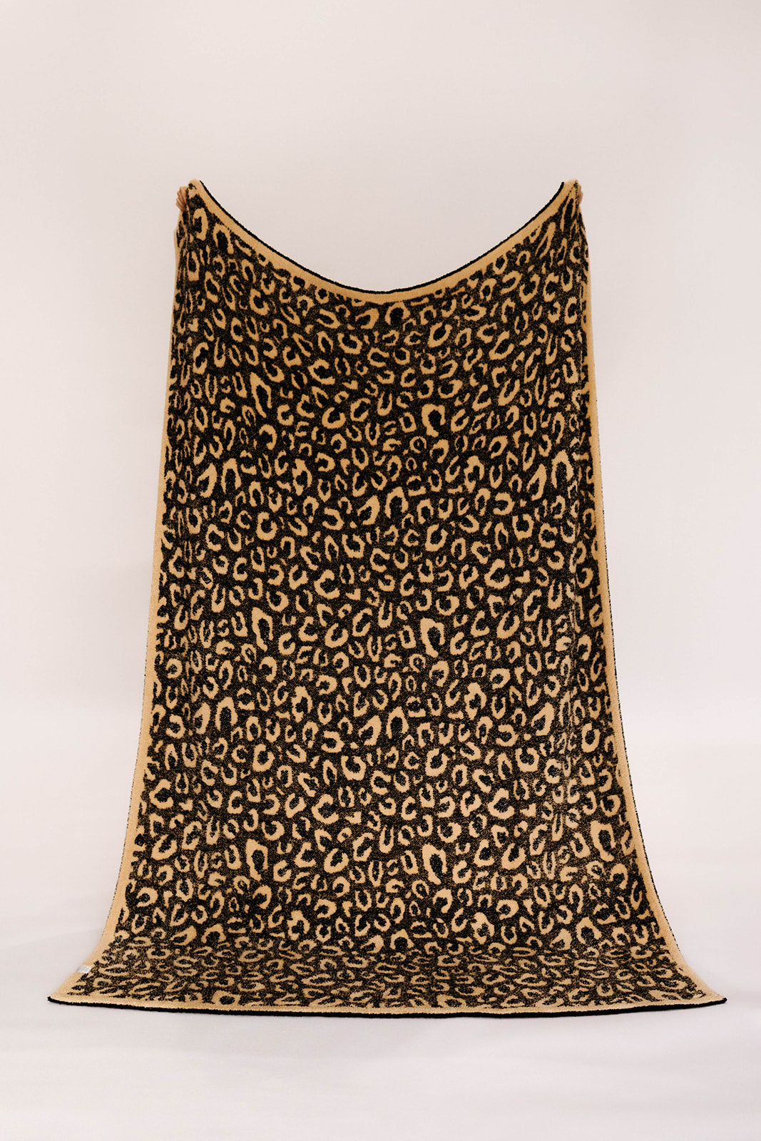 Leopard print blanket on a white background