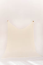 oversized cream blanket on a white wall