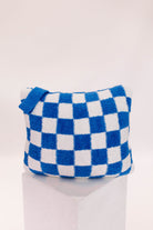 Blue and white checkered pillow on a white background