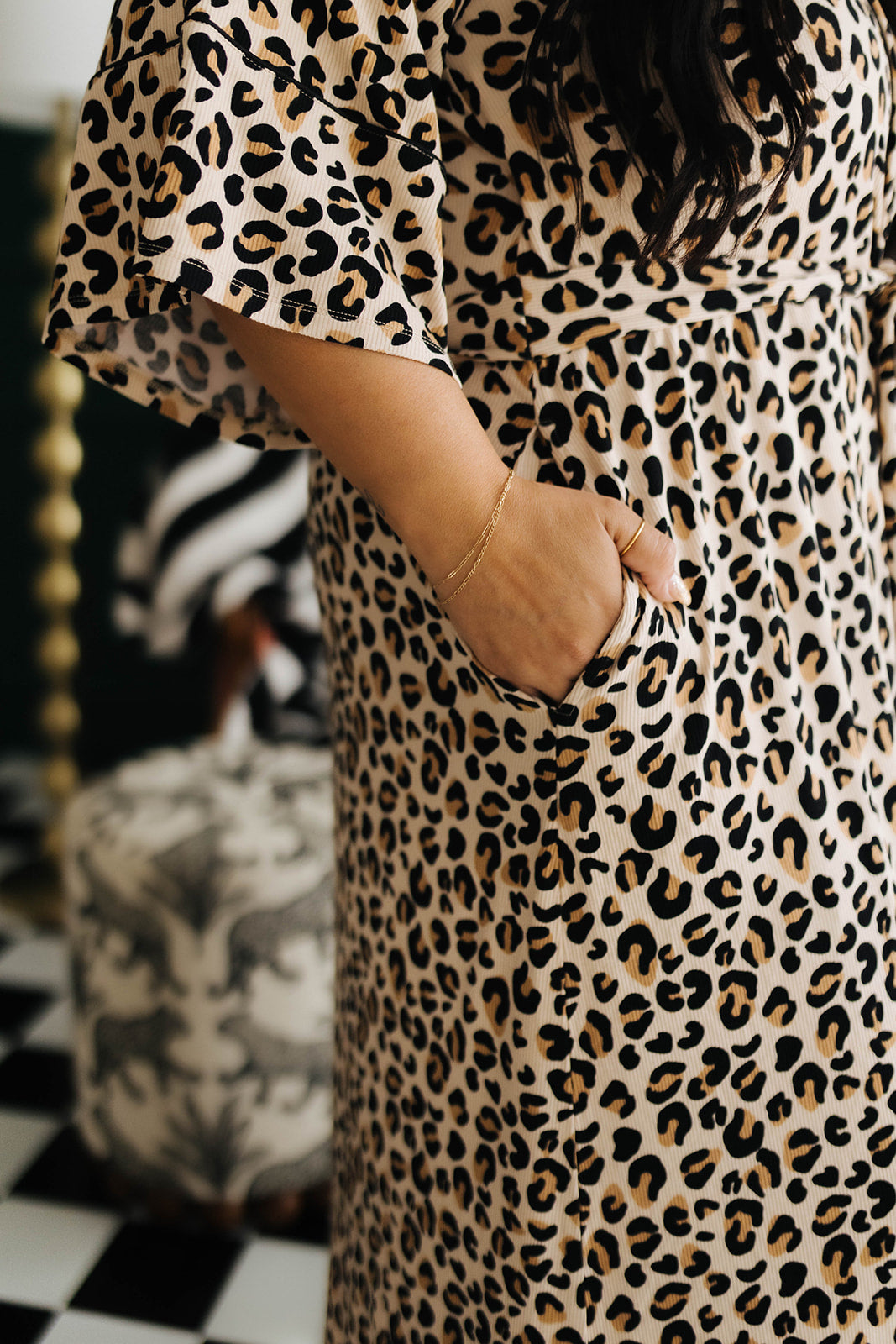Person wearing a leopard print outfit with a blurred background
