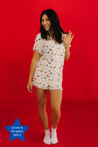Woman wearing a 4th of july patterned pajama set on a red background