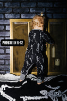 Phoebe wearing size 6 to 12 months in the Baby Skelly Ribbed Zip Pajamas