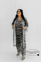 model regina wearing the size extra large in the skeleton pajamas and robe 