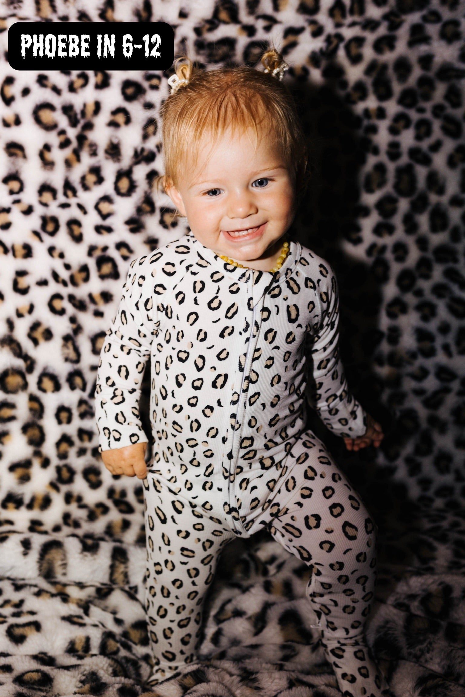 phoebe in leopard onesie with an ico that says 6-12 months