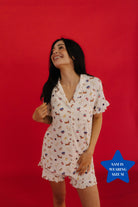 Woman wearing a 4th of july icon pj against a red background