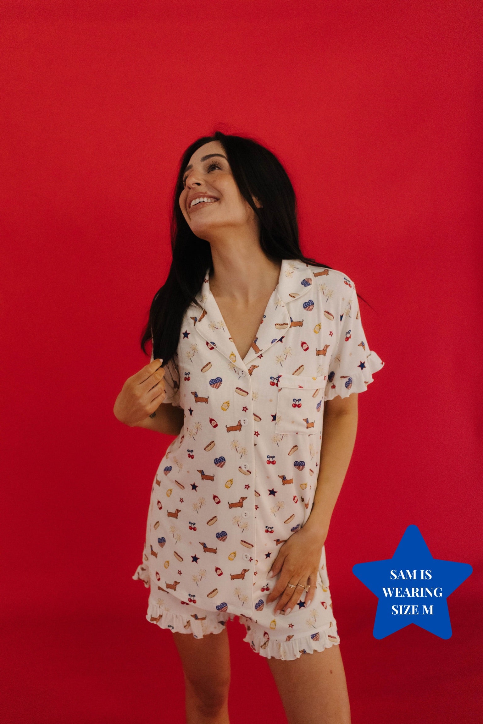 Woman wearing a 4th of july icon pj against a red background