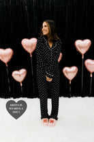 Krista holding her hands in front of her showing the black and white heart pjs 