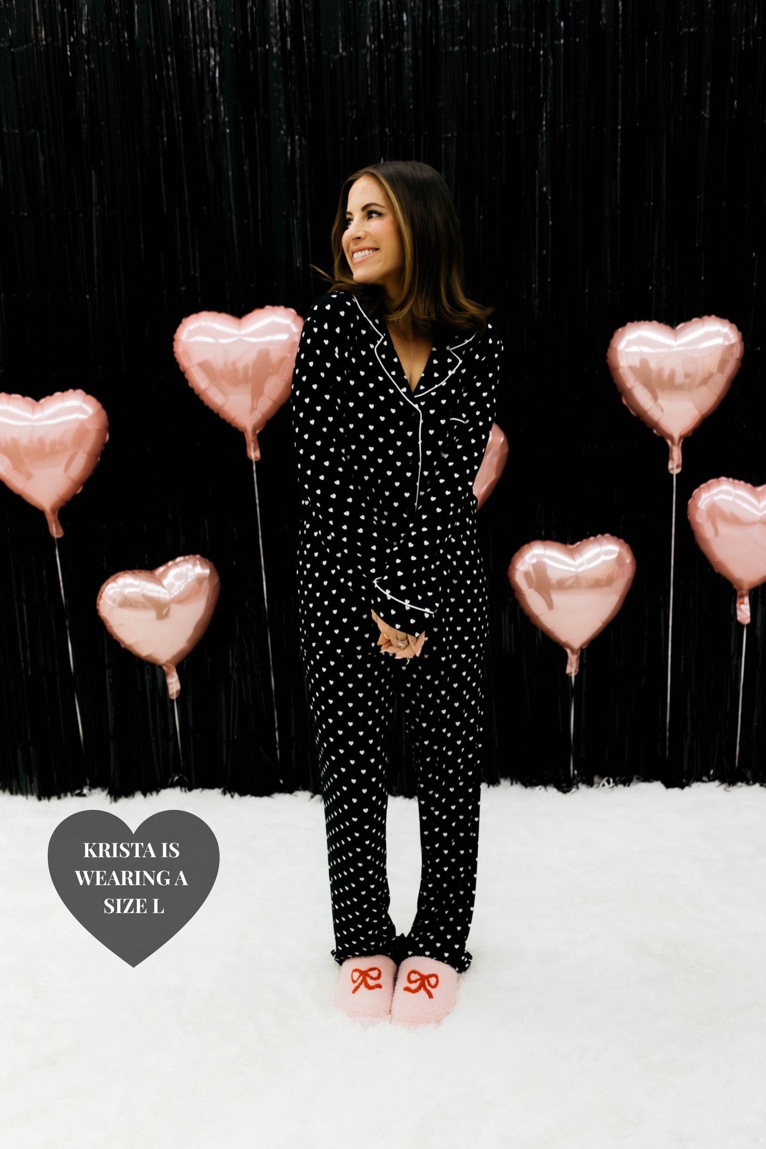 Krista holding her hands in front of her showing the black and white heart pjs 