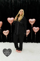 Ens smiling and looking up while holding her blonde hair - wearing the 2xl