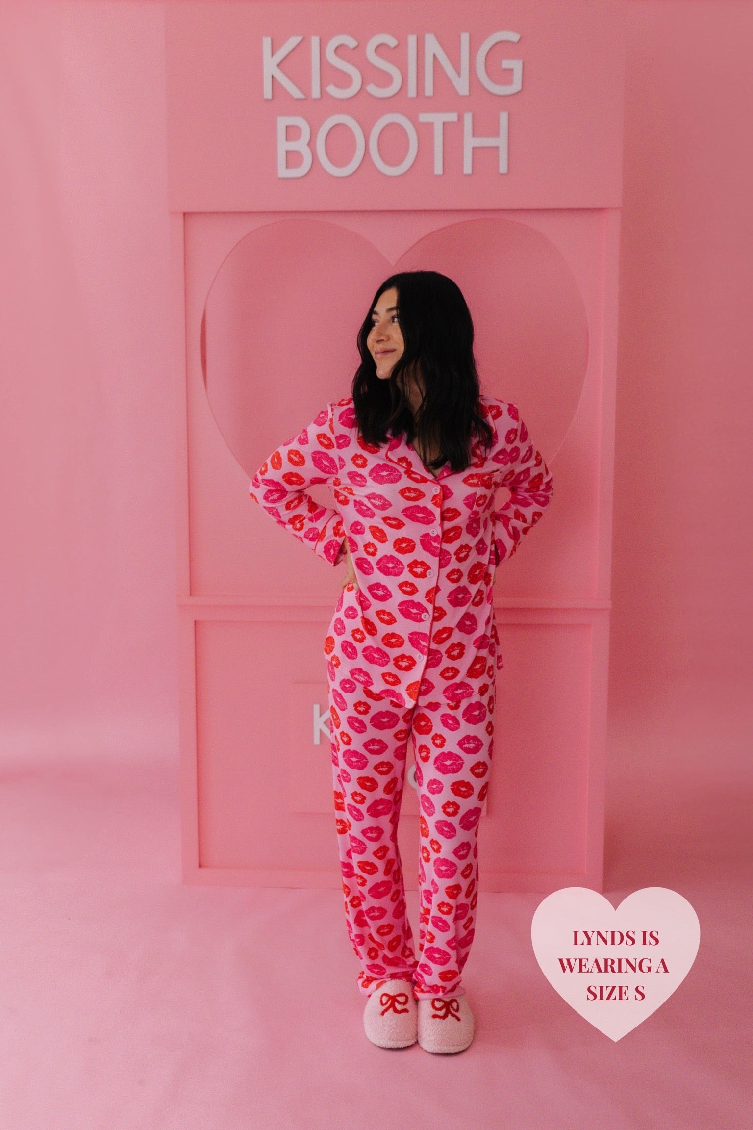 Lynds in the S pjs in front of the kissing booth posing 