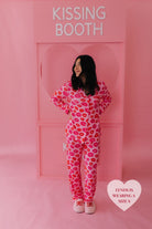 Lynds in the S pjs in front of the kissing booth posing 