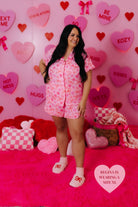 Regina wearing the XL smiling with her hand on her hip looking to the right 