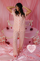 Mayra smiling with her hands behind her head smiling 