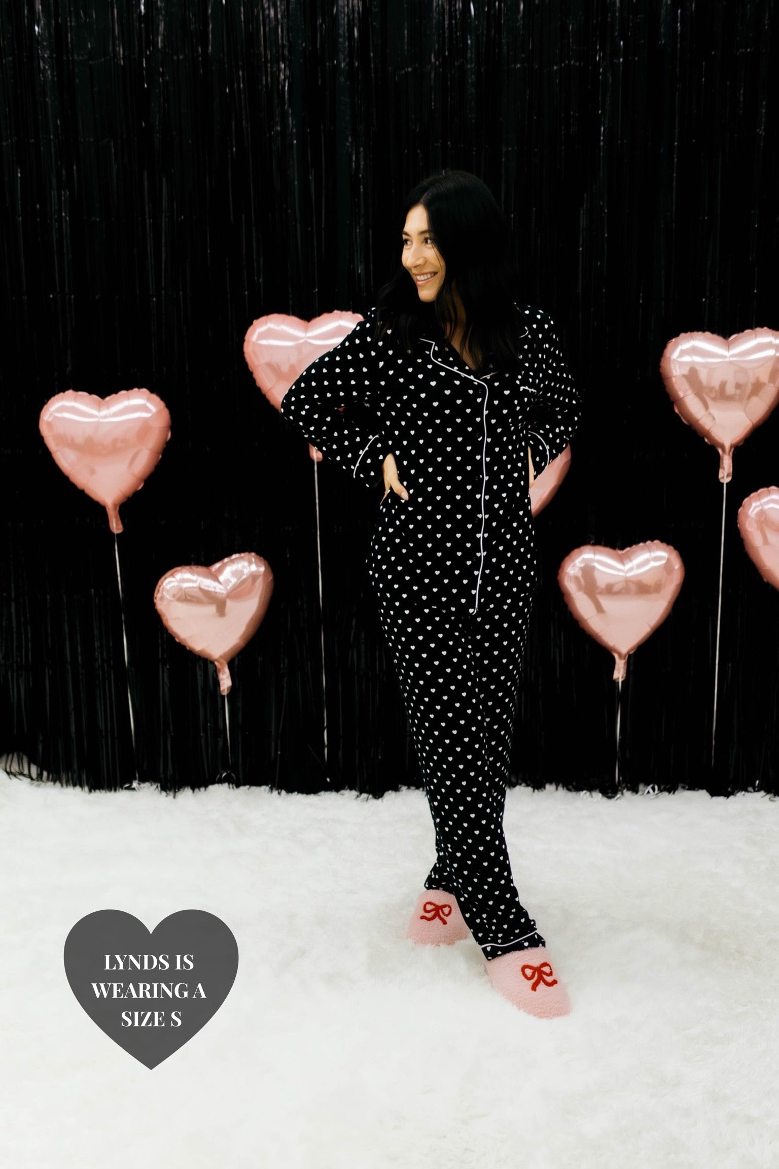 Lynds wearing the size small posing and holding her hands on her stomach looking to the site 