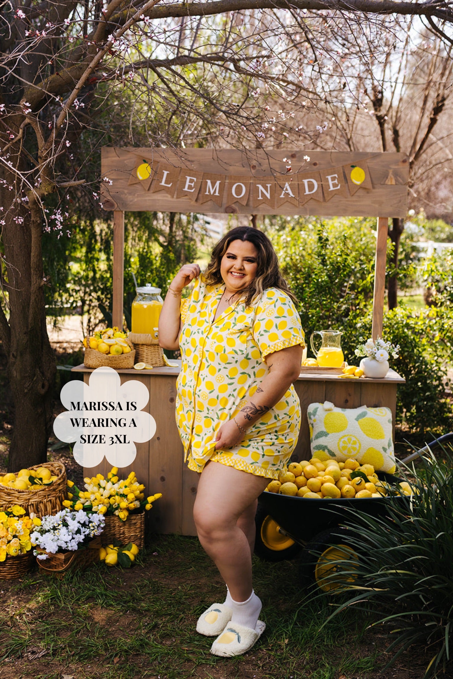 Woman in a yellow outfit standing next to a lemonade stand with lemons and a 'Lemonade' sign.