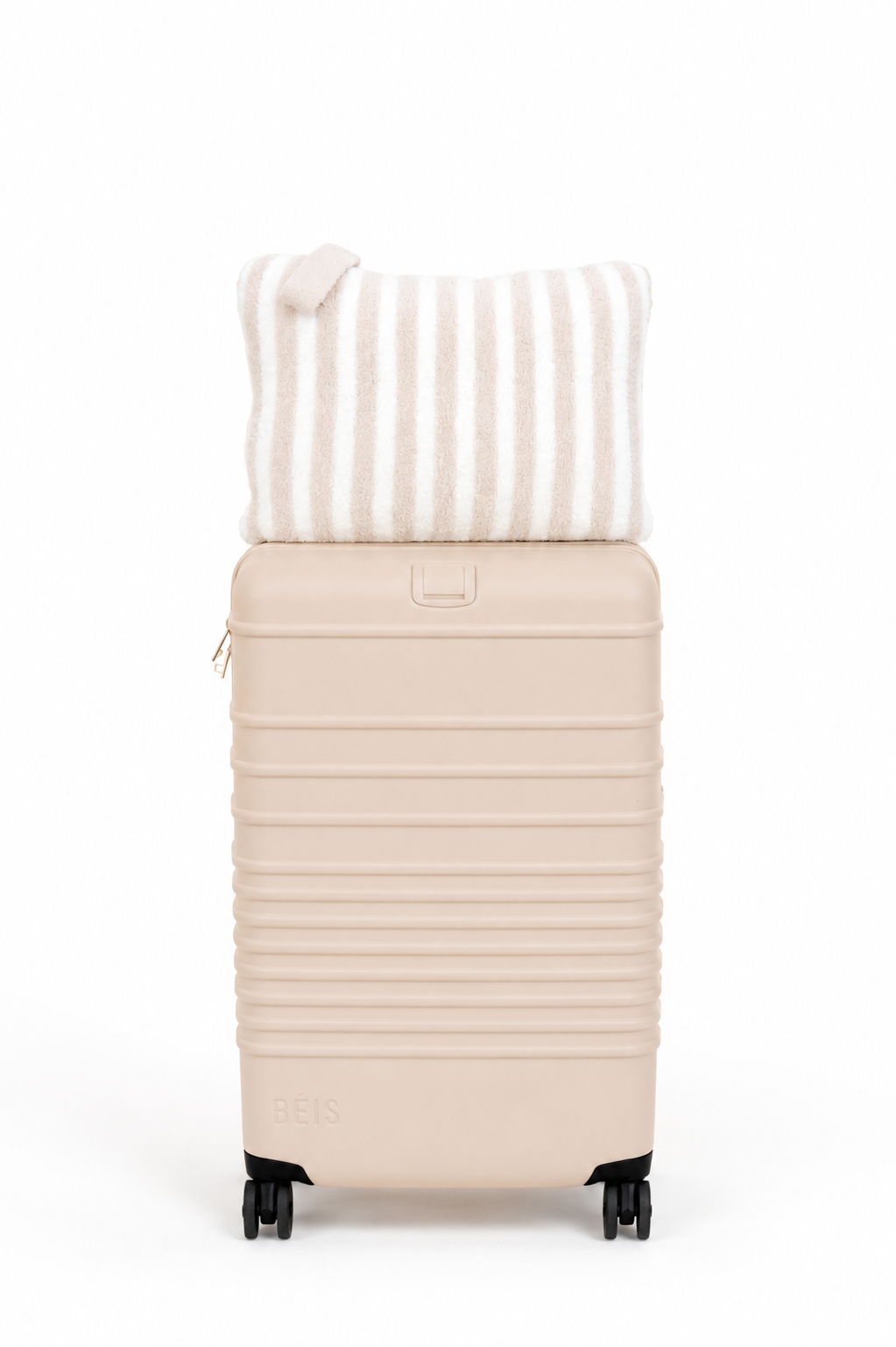 Beige suitcase with a striped pillow on a white background