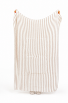 Person holding striped quillow up 