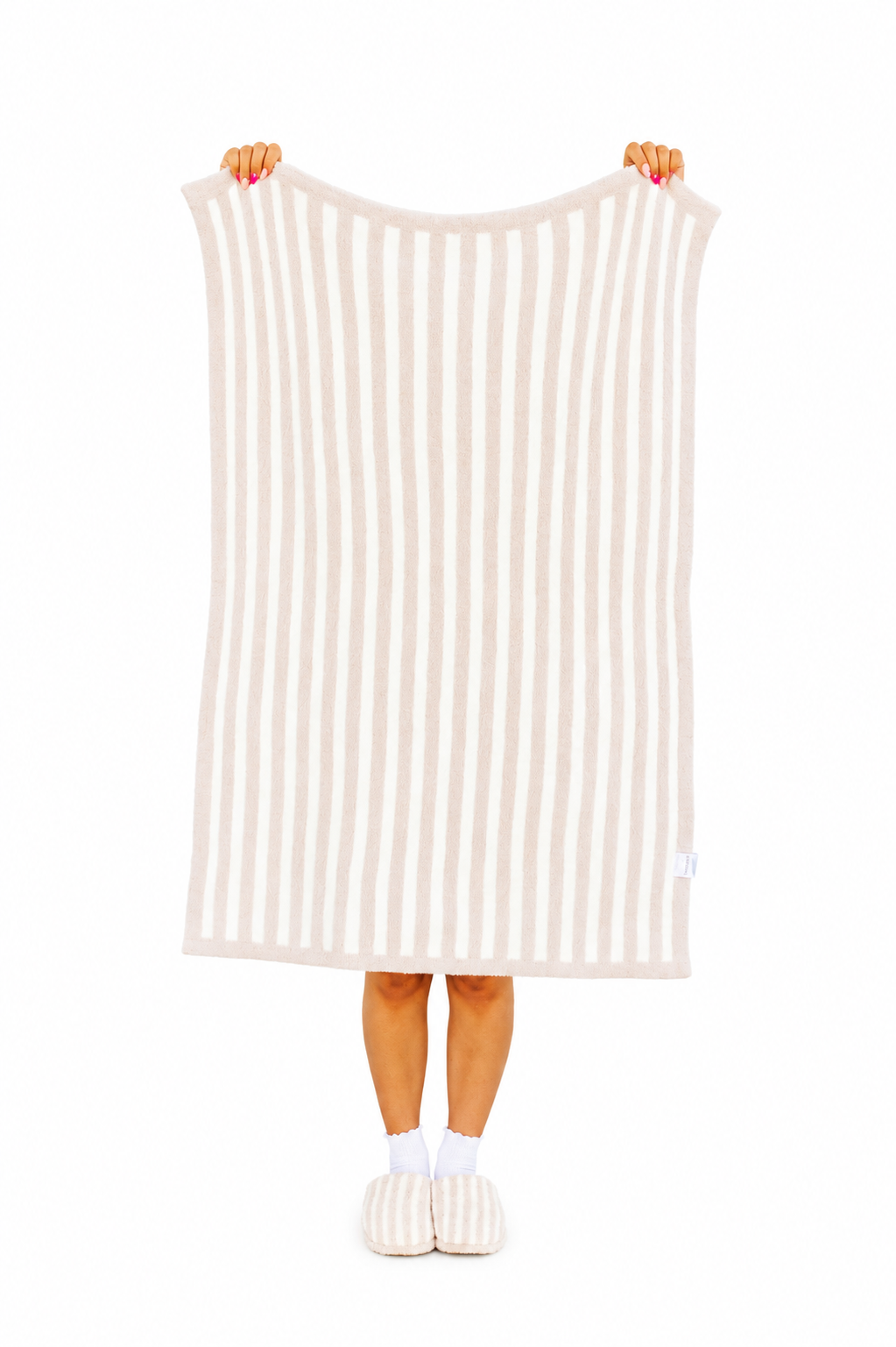 Person holding a striped blanket with white background