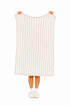 Person holding a striped blanket with white background