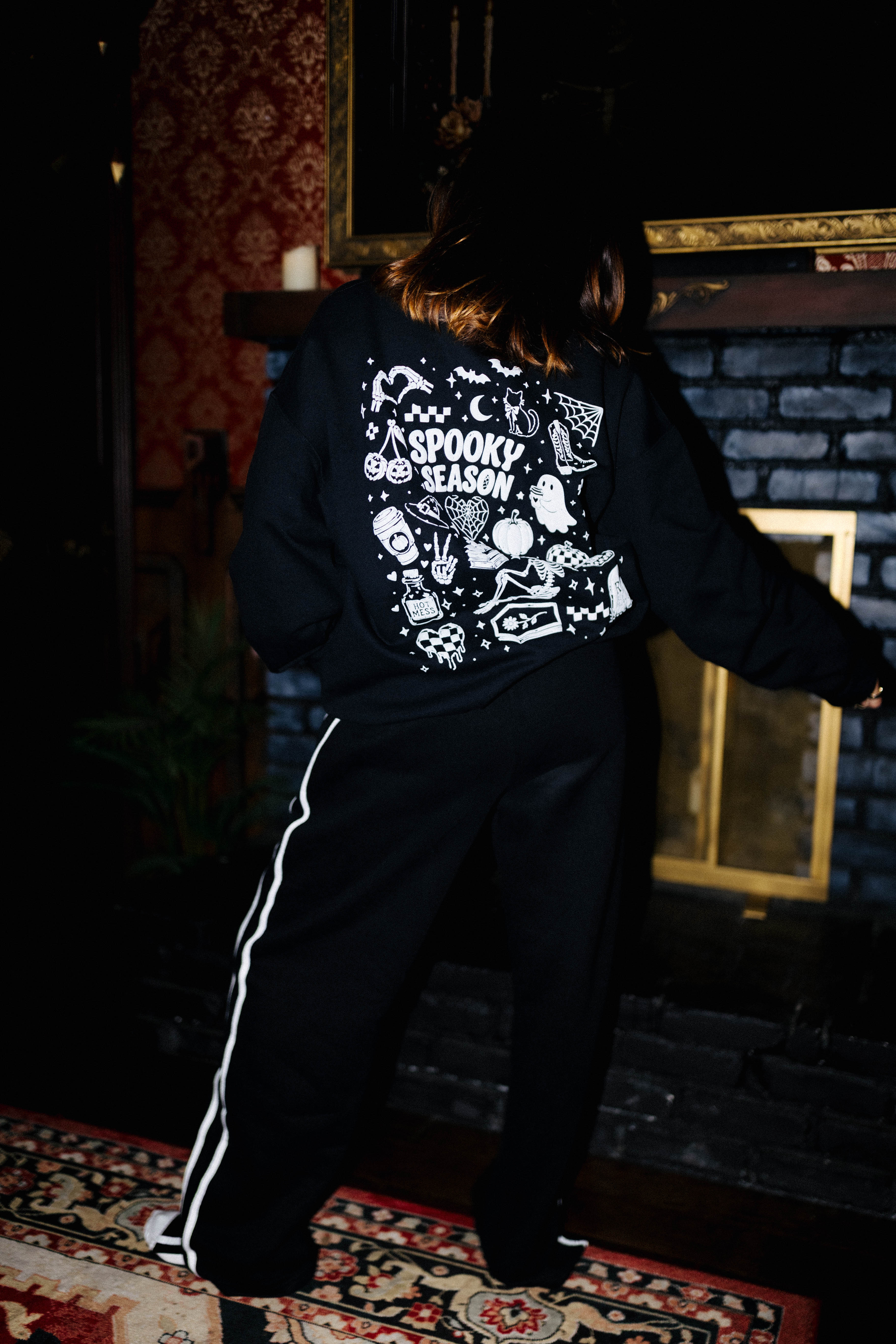 Back view of black sweatpants with white side stripes