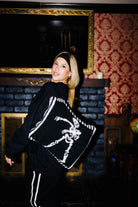 Model wearing the Skelly quillow as a backpack