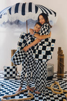 Krista and Boss hugging while wearing the check pieces
