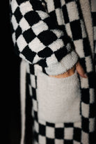 Close view of the fluffy check robe cuff and pocket