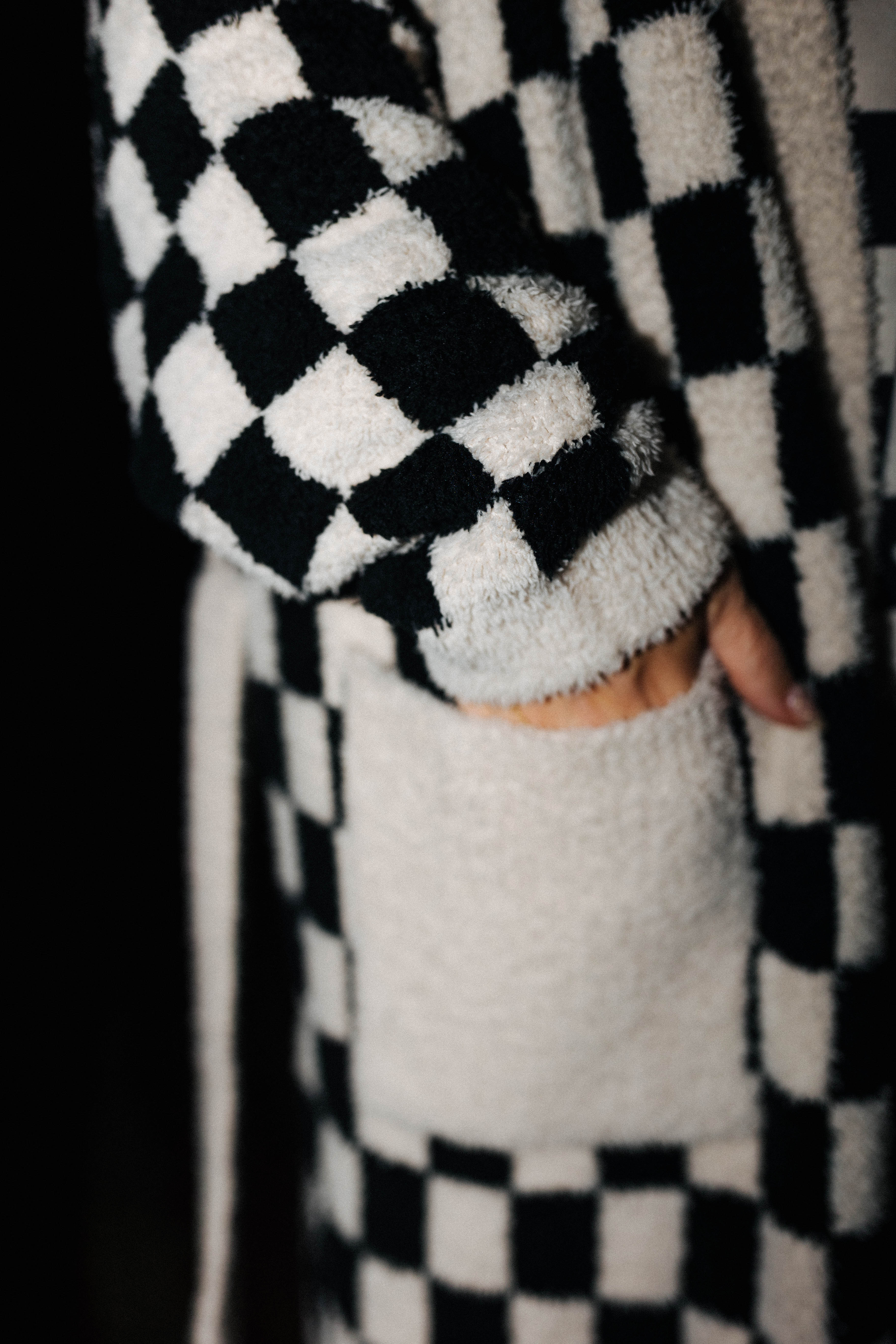 Close view of the fluffy check robe cuff and pocket