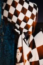 Close view of a ghost motif on the check blanket