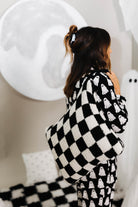 model krista wearing ghost pajamas hanging black check quillow over shoulder