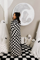 model krista smiling with black check quillow opened smiling with quillow opened and wrapped around her 