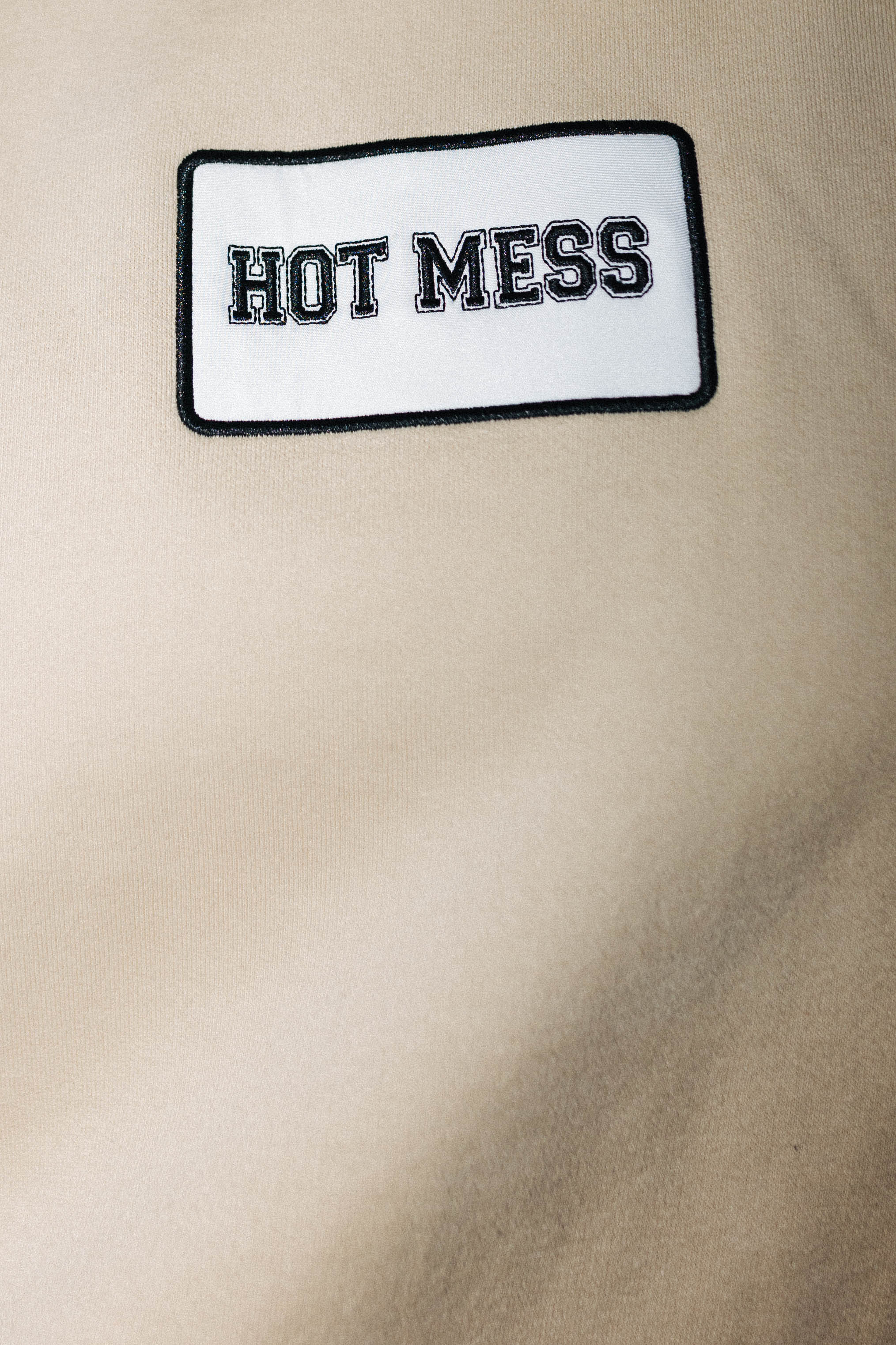 Hot Mess patch on sand sweatshirt