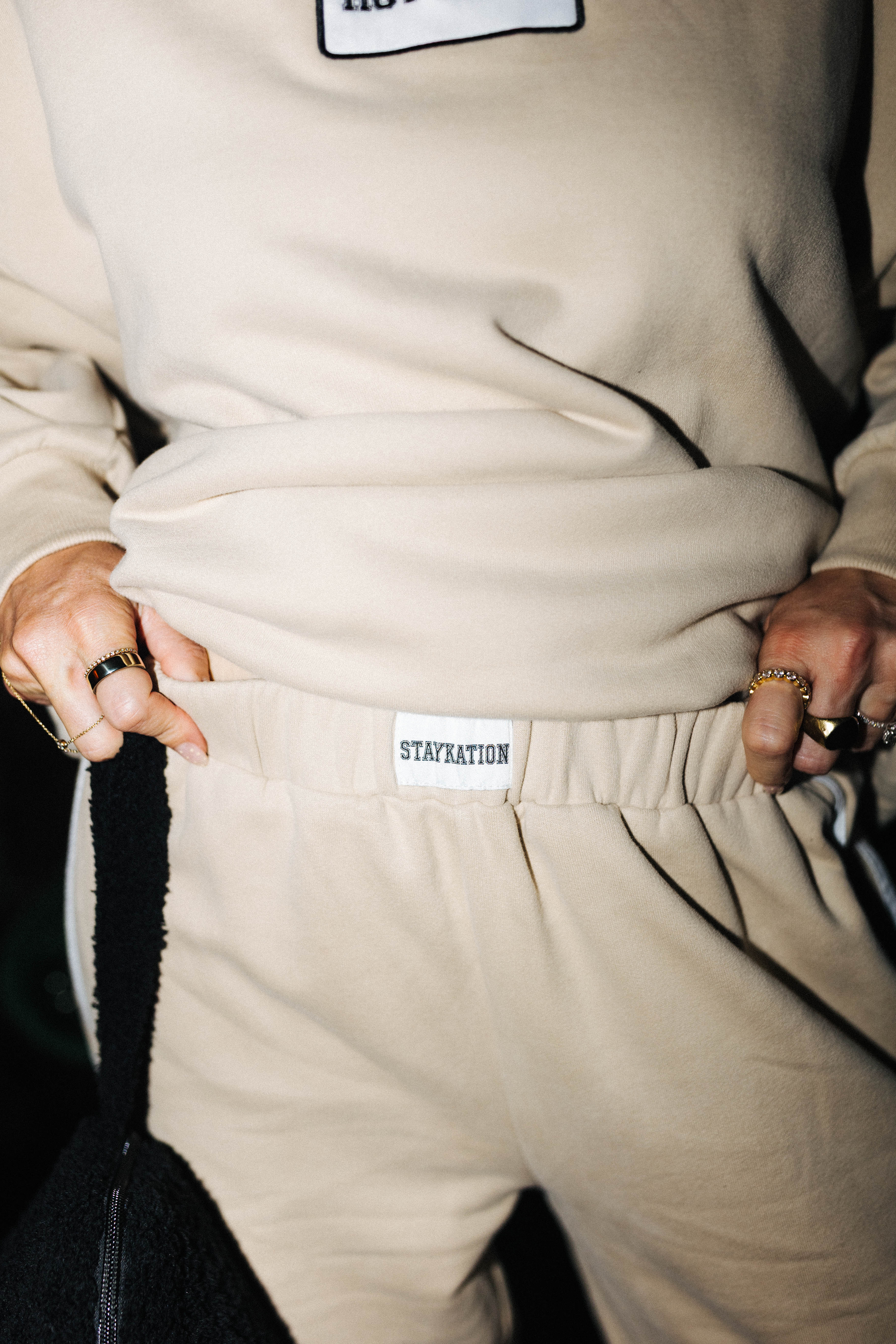 Close view of the tan sweatpants waistband label