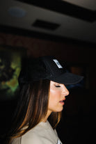 Side view of the black Hot Mess trucker hat