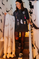 model krista on the staircase wearing hot ghoul tee holding the bat blanket with bat decorations in the background 