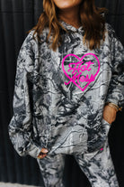 model wearing hot mess at heart camo hoodie with hand in pocket 