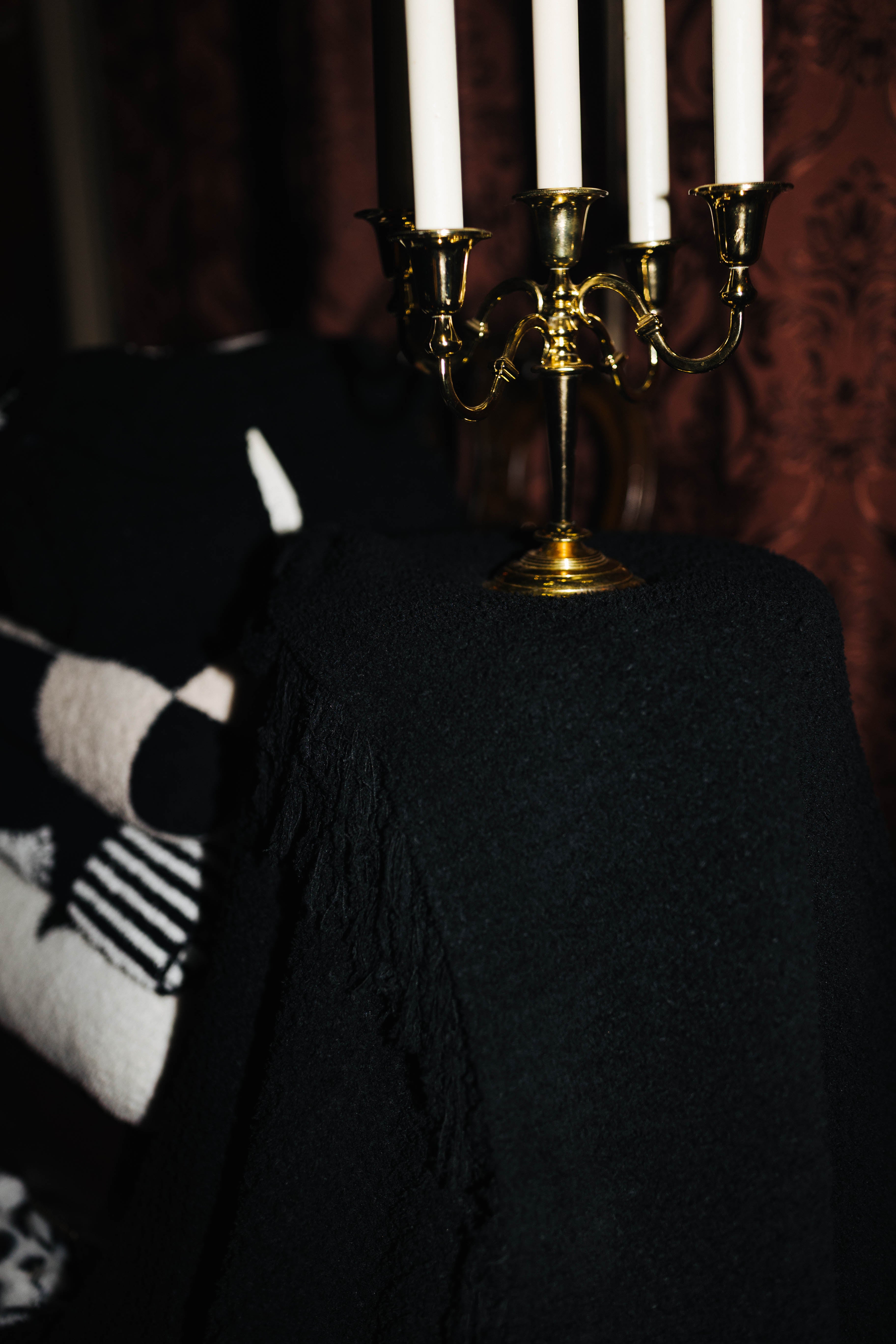 Black Waffle Fringe Blanket 90x90 shown in a full length lifestyle view