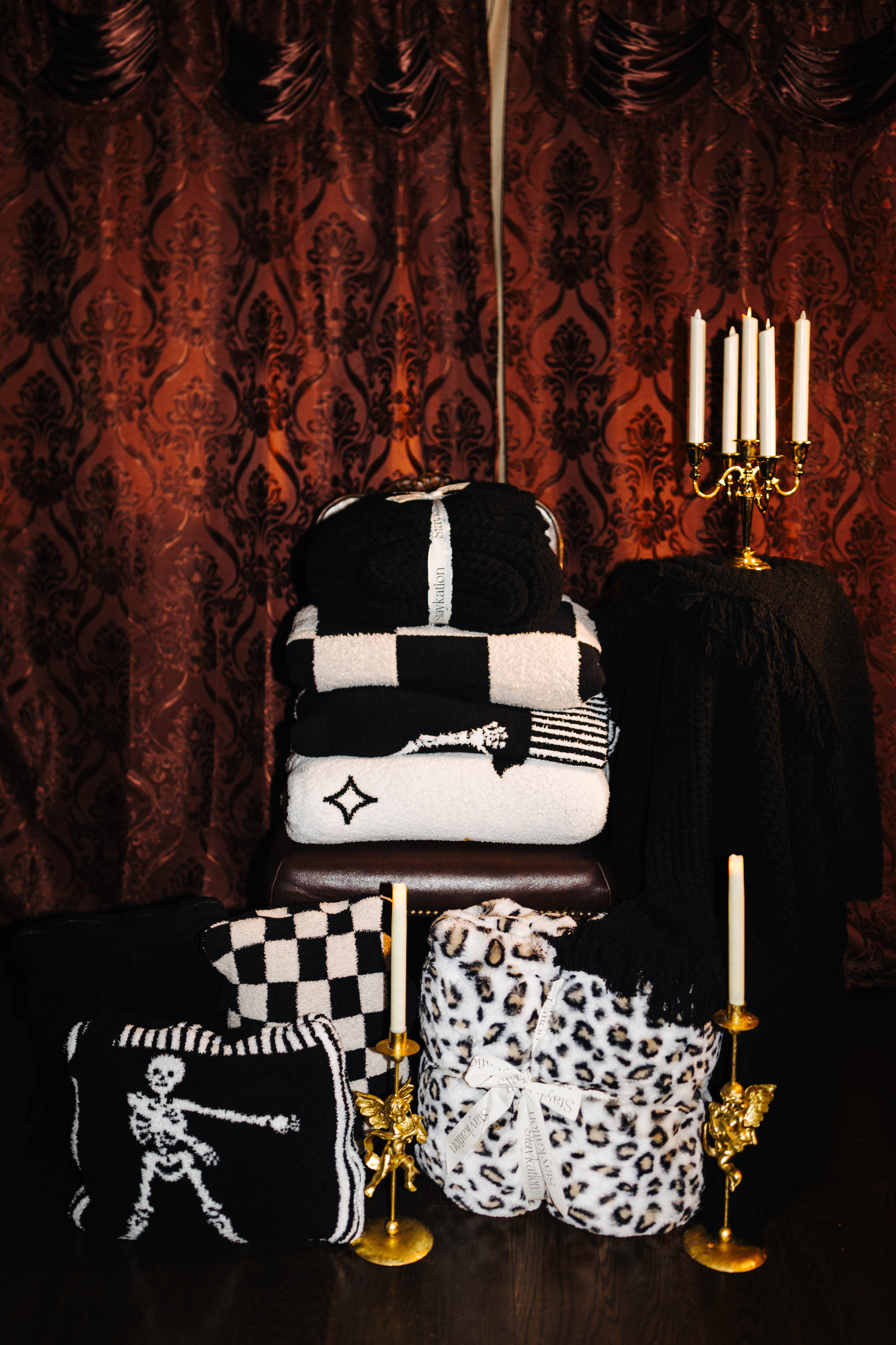 Staykation Halloween collection lifestyle photo featuring Black Waffle Quillow 50x60 and Black Waffle Fringe Blanket 90x90
