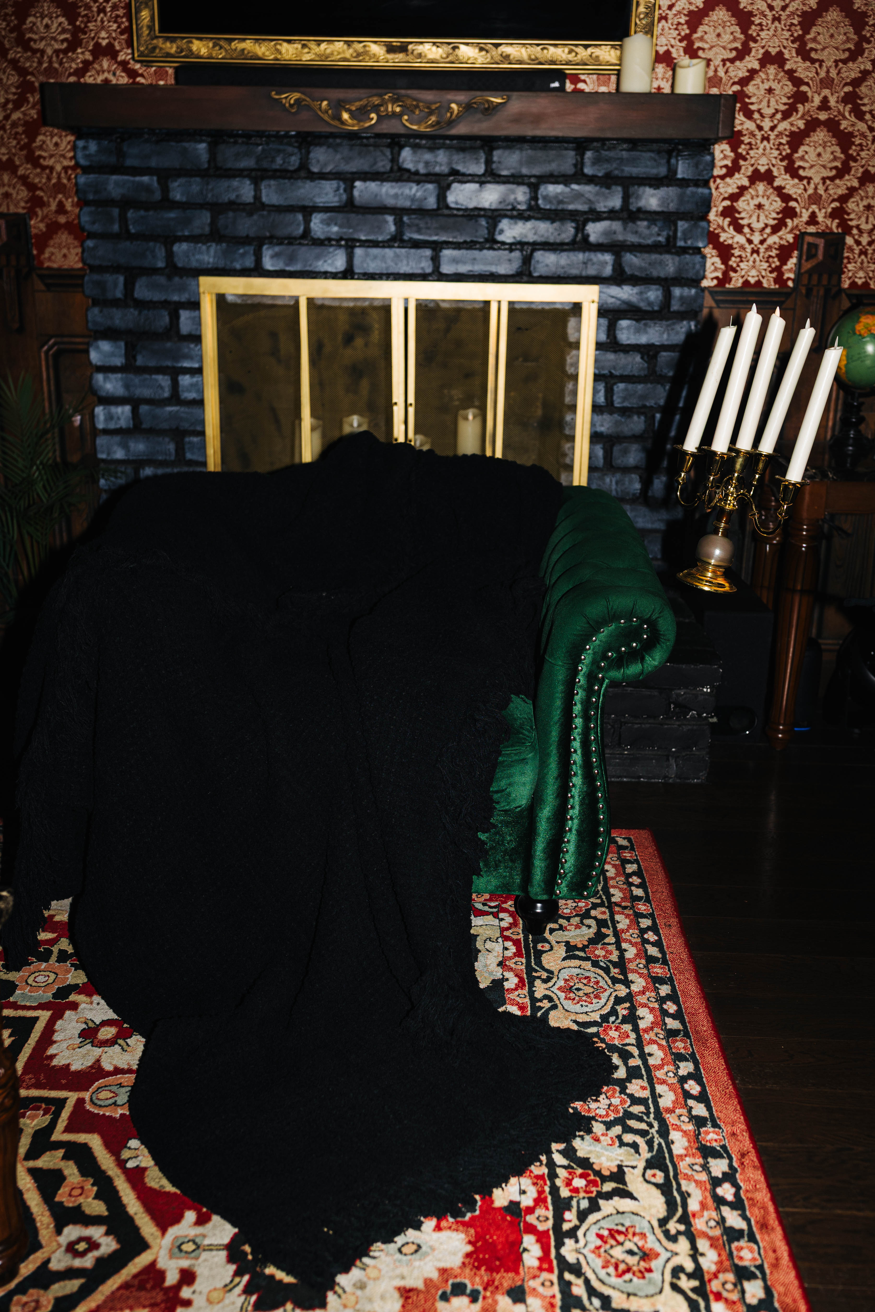 Black waffle fringe blanket draped over a green chair