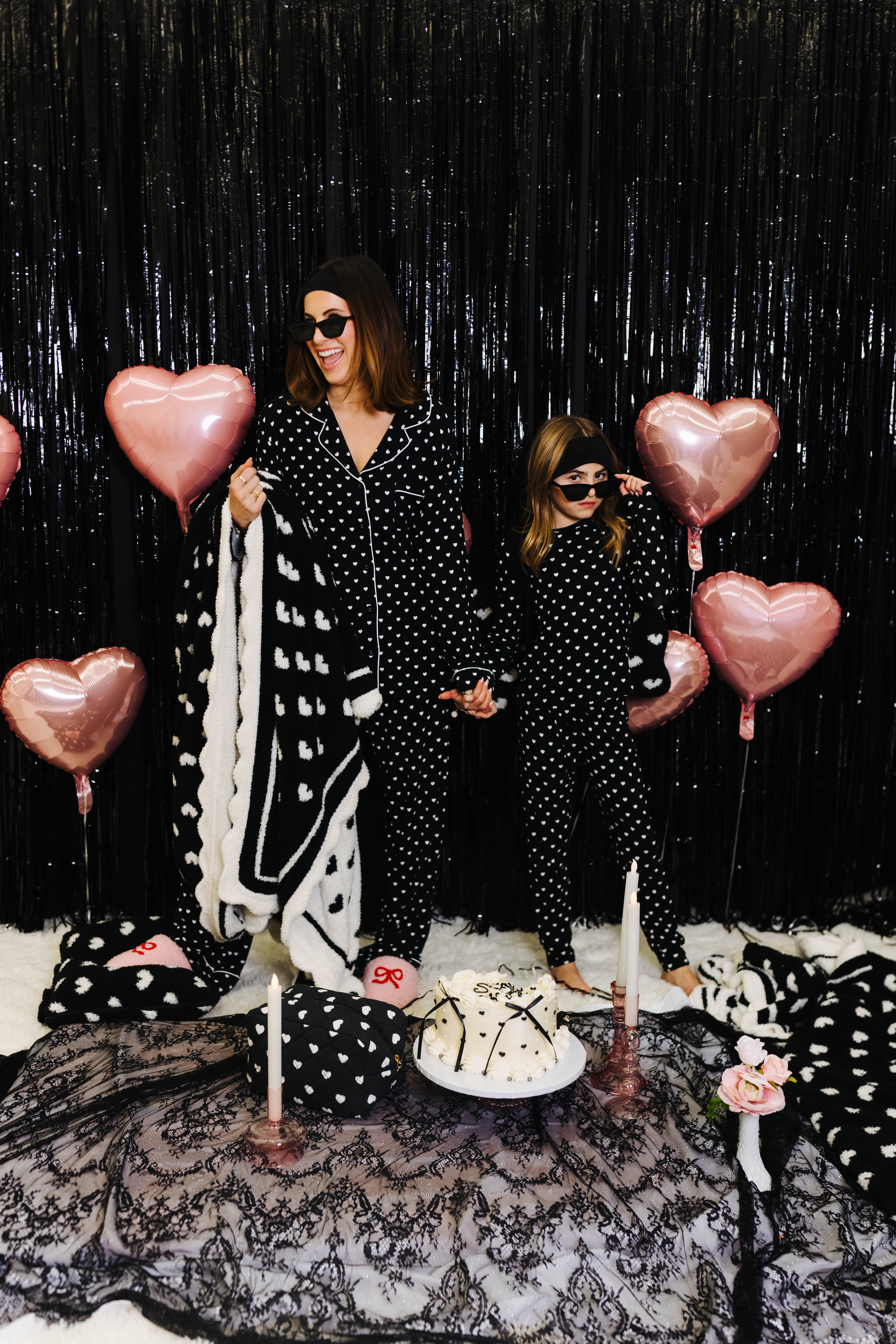 Krista and Kolly holding the black and white heart blanket
