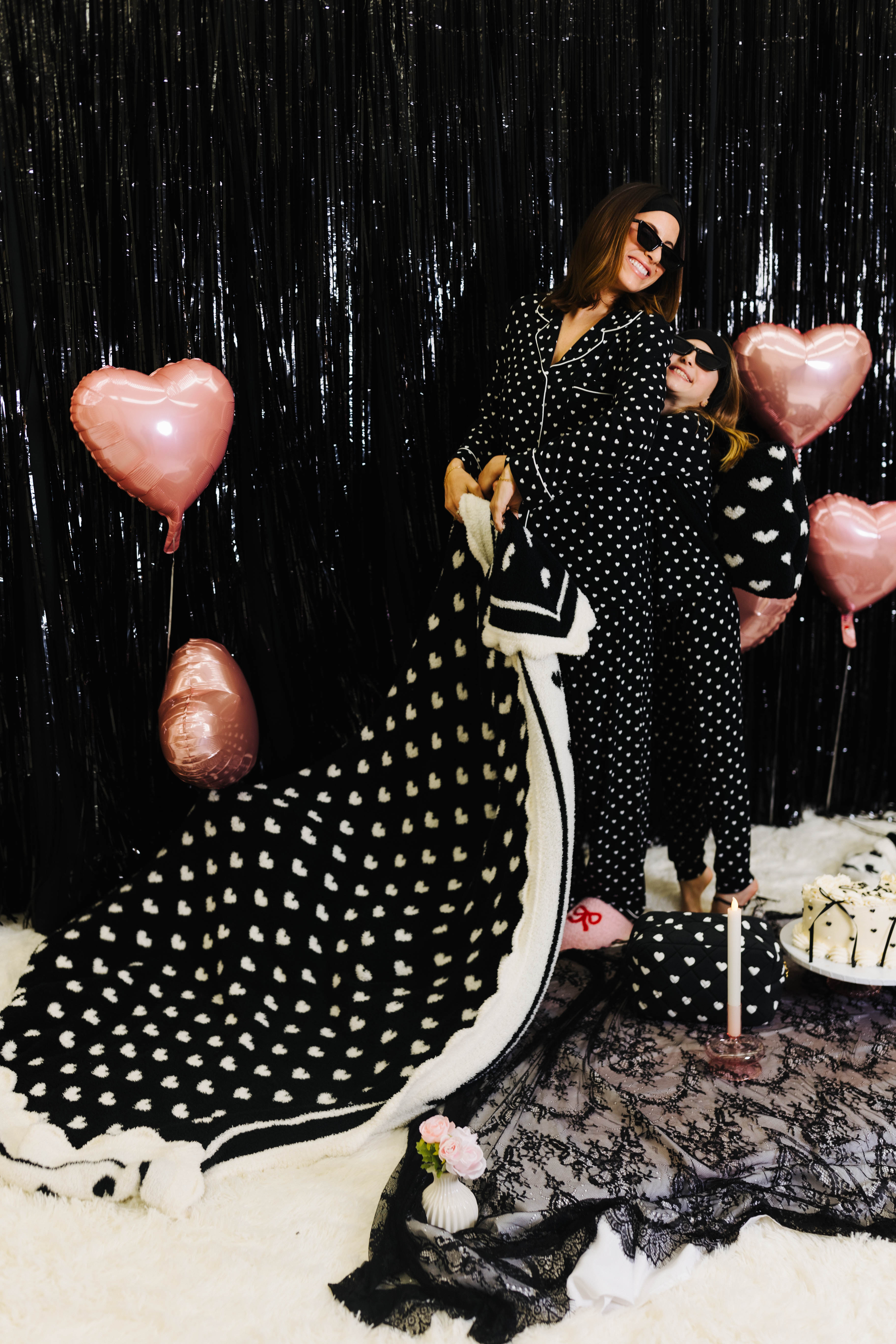 Kolly hugging Krista while she holds the black and white heart blanket