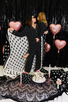 Krista holding kolly and showing the white side of the black and white heart blanket