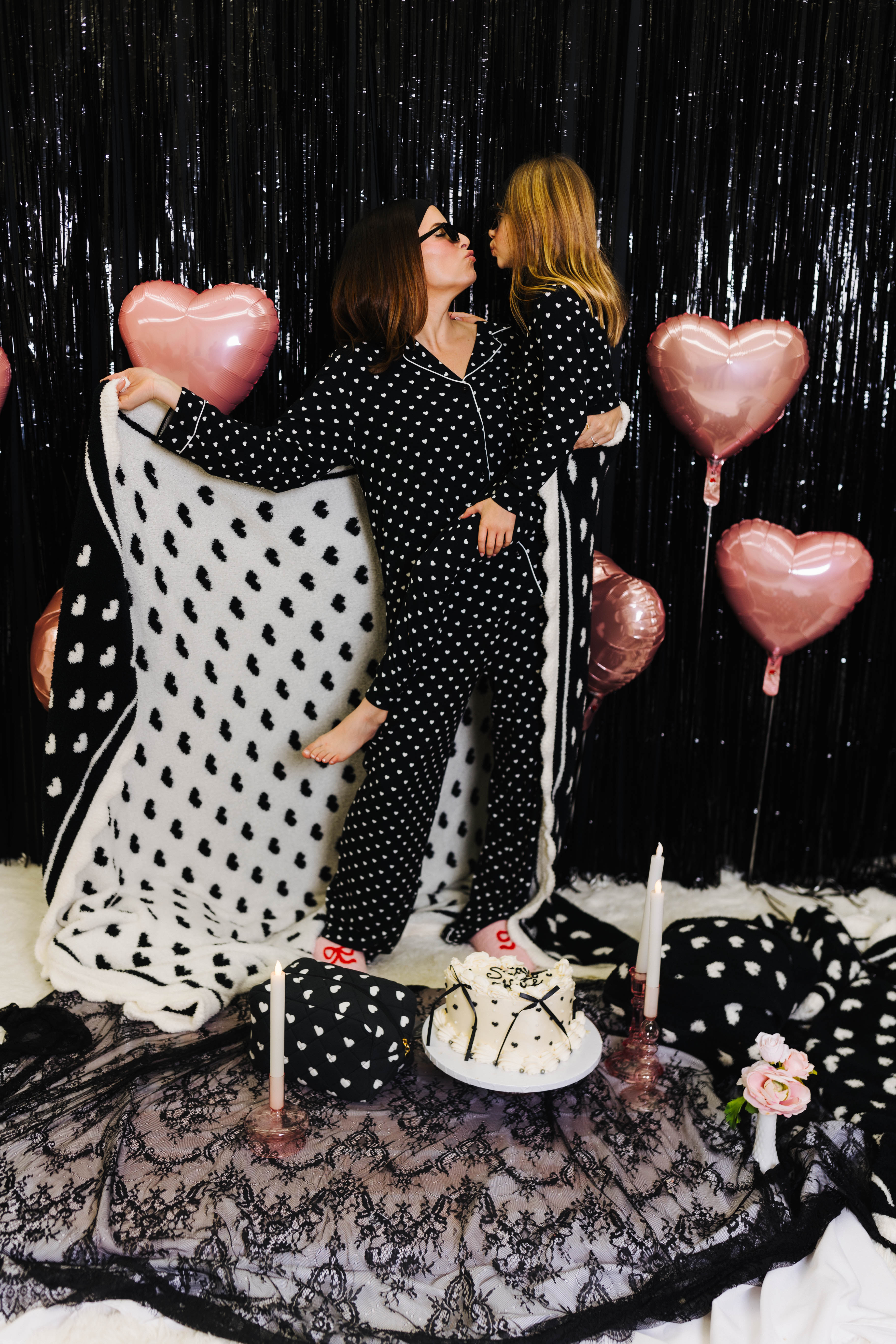 Krista holding kolly and showing the white side of the black and white heart blanket