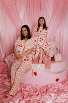 Krista and Kolly holding the quillow and wrapped in the quillow on the faux cake mold