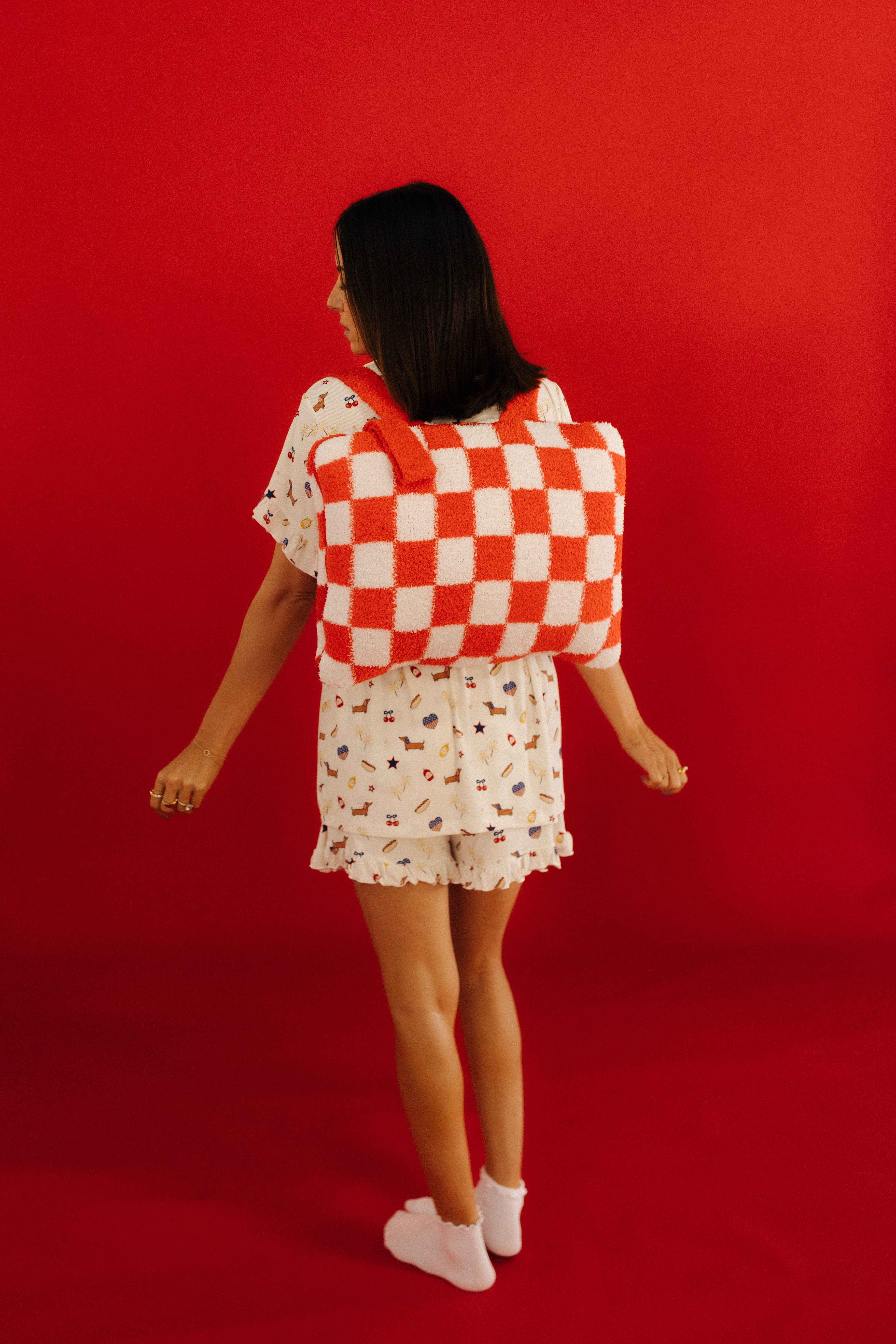 red quillow on Krista's back showing the backpack function
